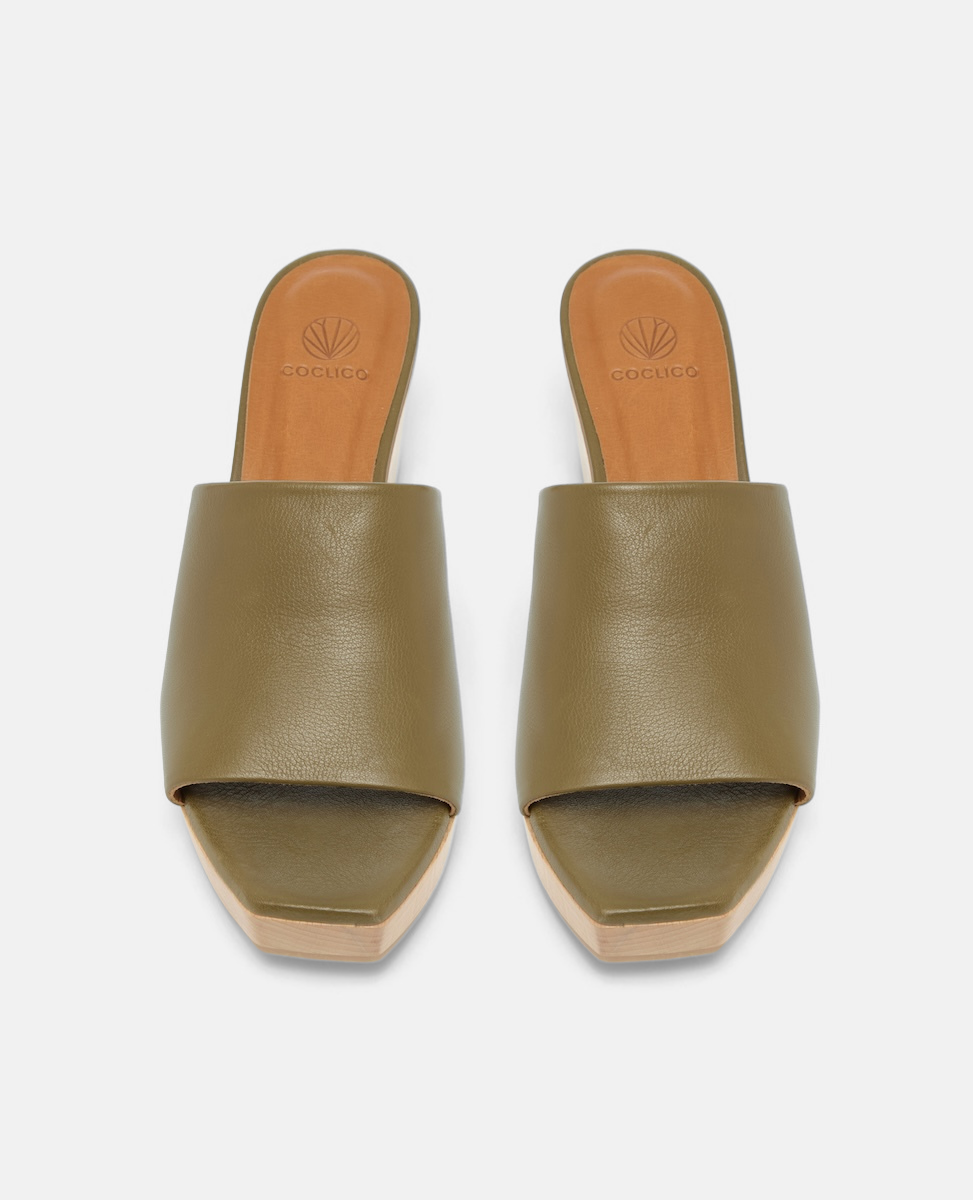 A stylish clog sandal featuring an olive green leather upper, an open toe design, and a light wooden block heel and platform. Top View