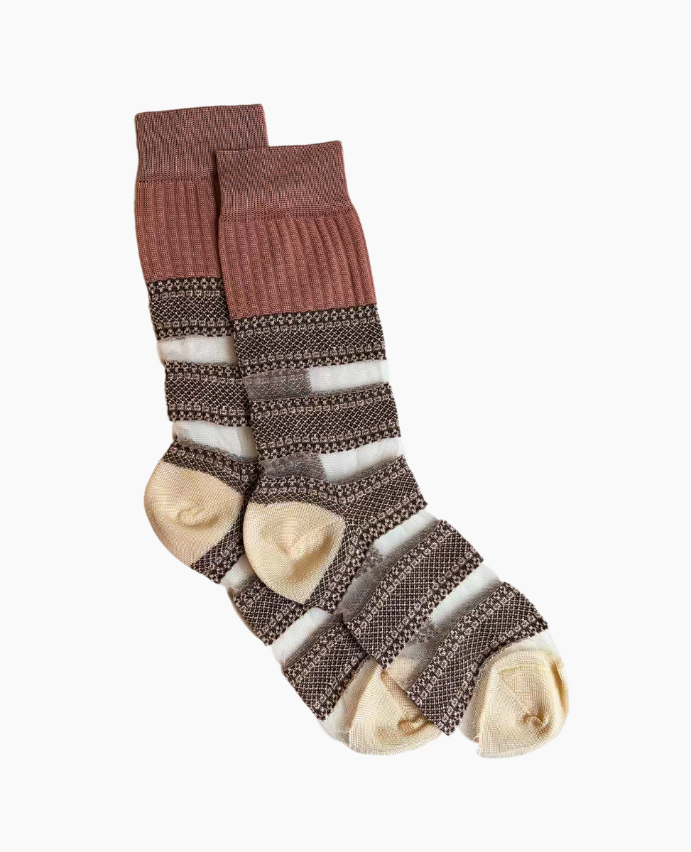 A pair of mid-calf socks featuring a ribbed cuff in a muted pink color, with alternating horizontal stripes of brown, cream, and intricate black and white patterns, and beige toe and heel sections.