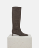 Dark gray knee-high boot on a white pedestal against a light gray background 4