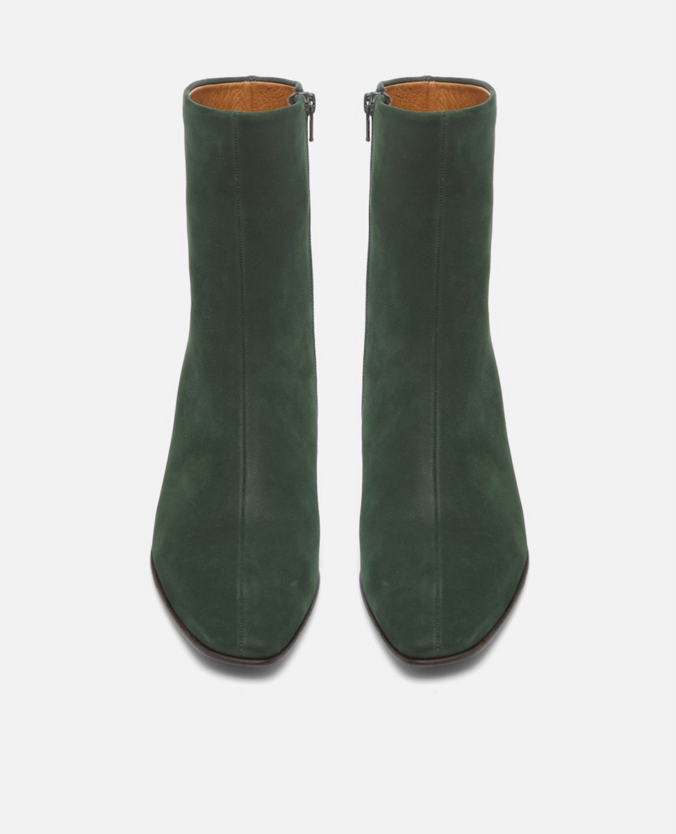 Pair of green ankle boots on a white background