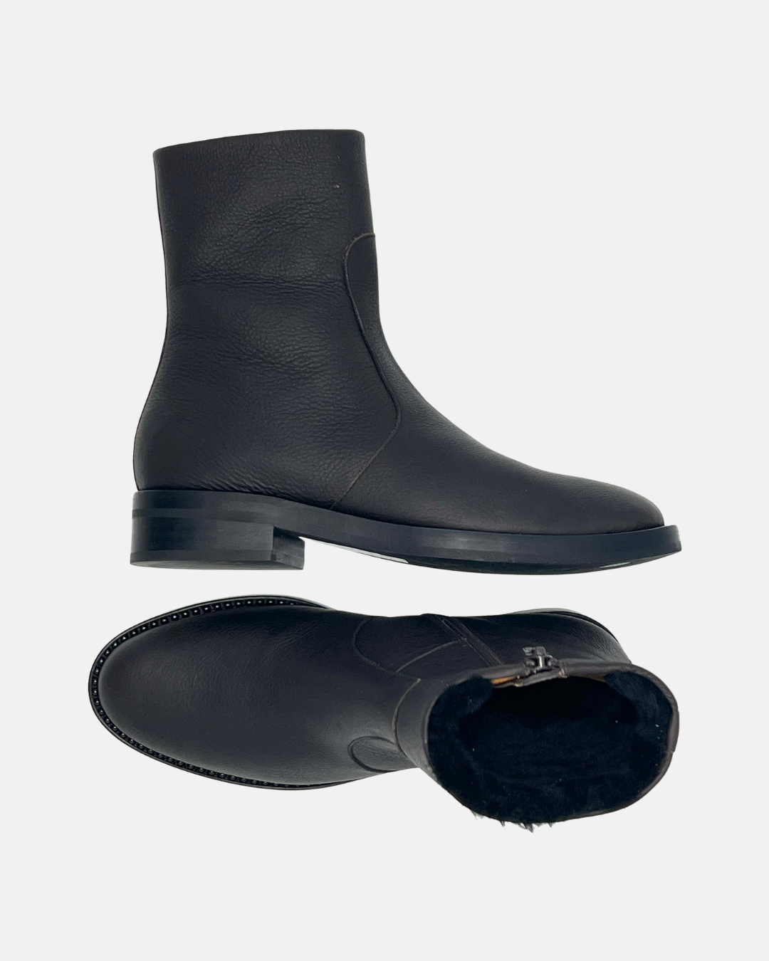 Coclico Theo Shearling Boot in black leather, a flat shearling lined boot with a slim ankle strap and single stud