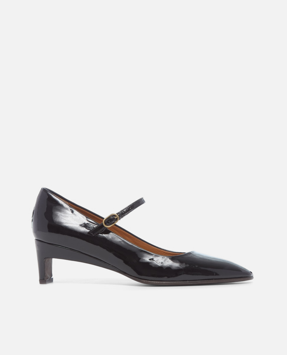 Black patent leather shoe with a strap on a white background