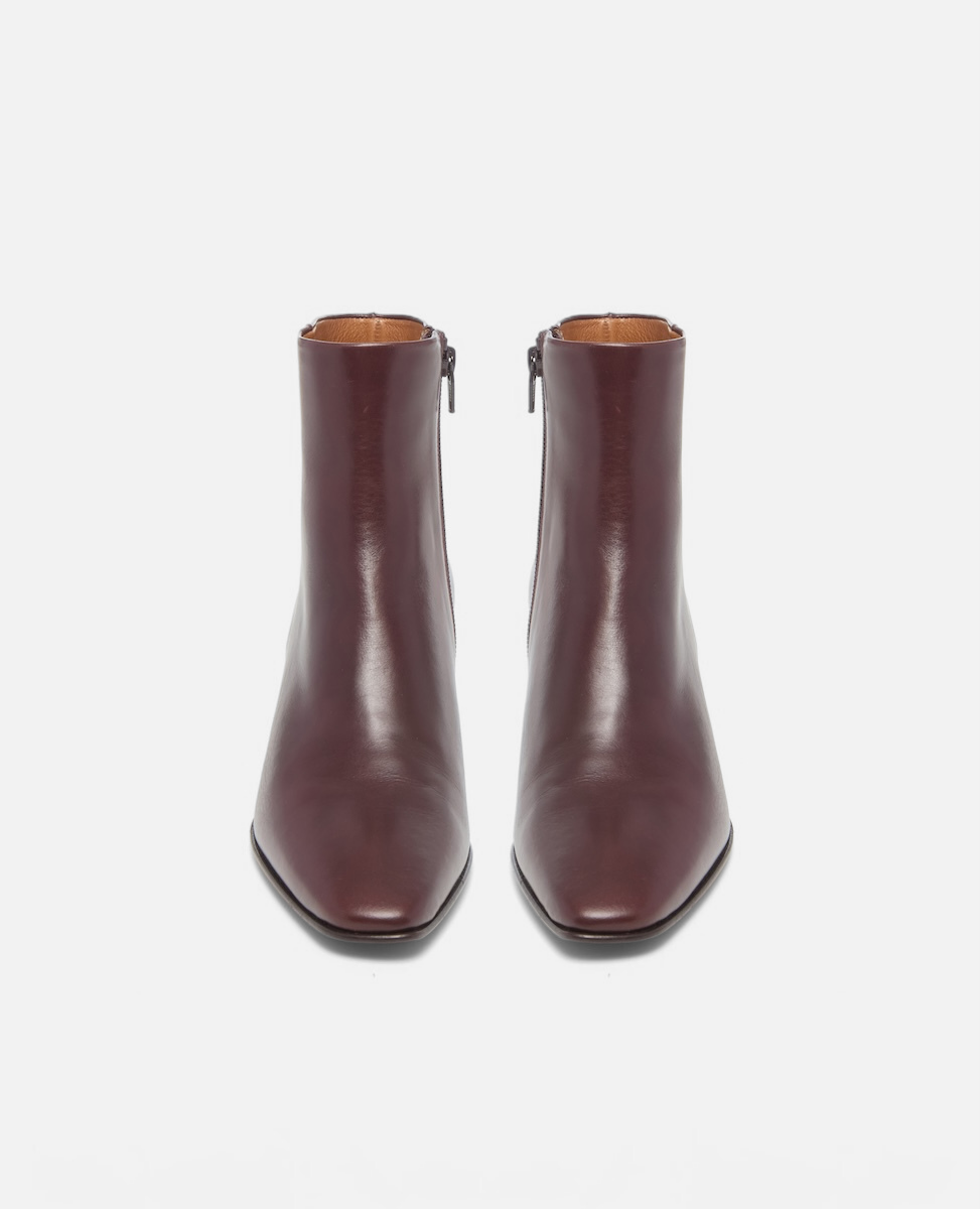 Pair of brown leather ankle boots on a white background
