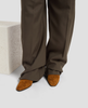 Brown pants and suede shoes on a light gray background 5