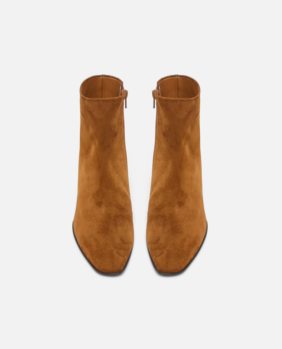 Pair of brown suede ankle boots on a white background