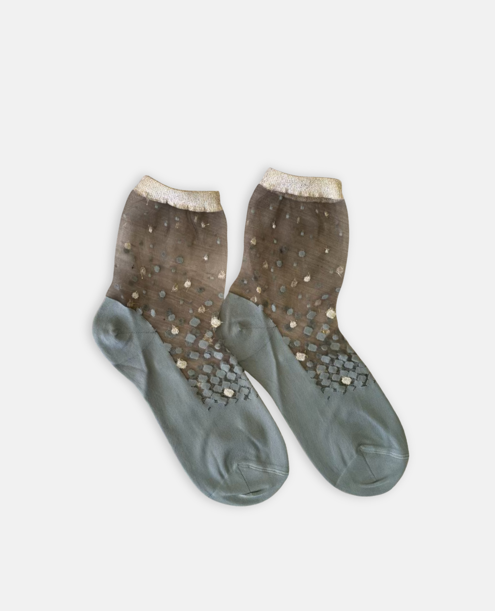 Pair of socks with glittery pattern on a light gray background