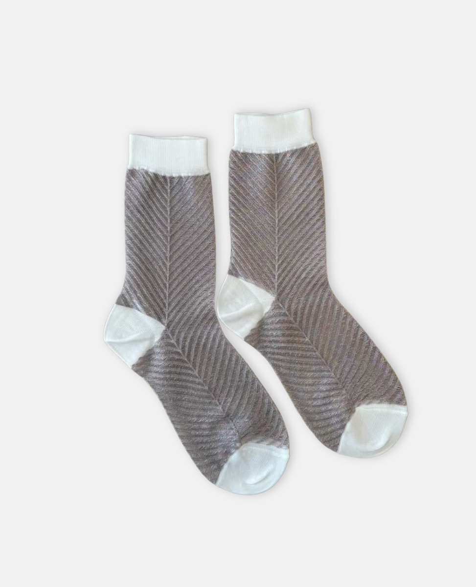 Pair of clear and silver socks with white accents on a light gray background