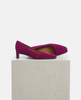 Pair of purple high-heeled shoes on a light gray pedestal against a white background 4