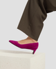 Purple high-heeled shoes worn with brown pants on a light background 5