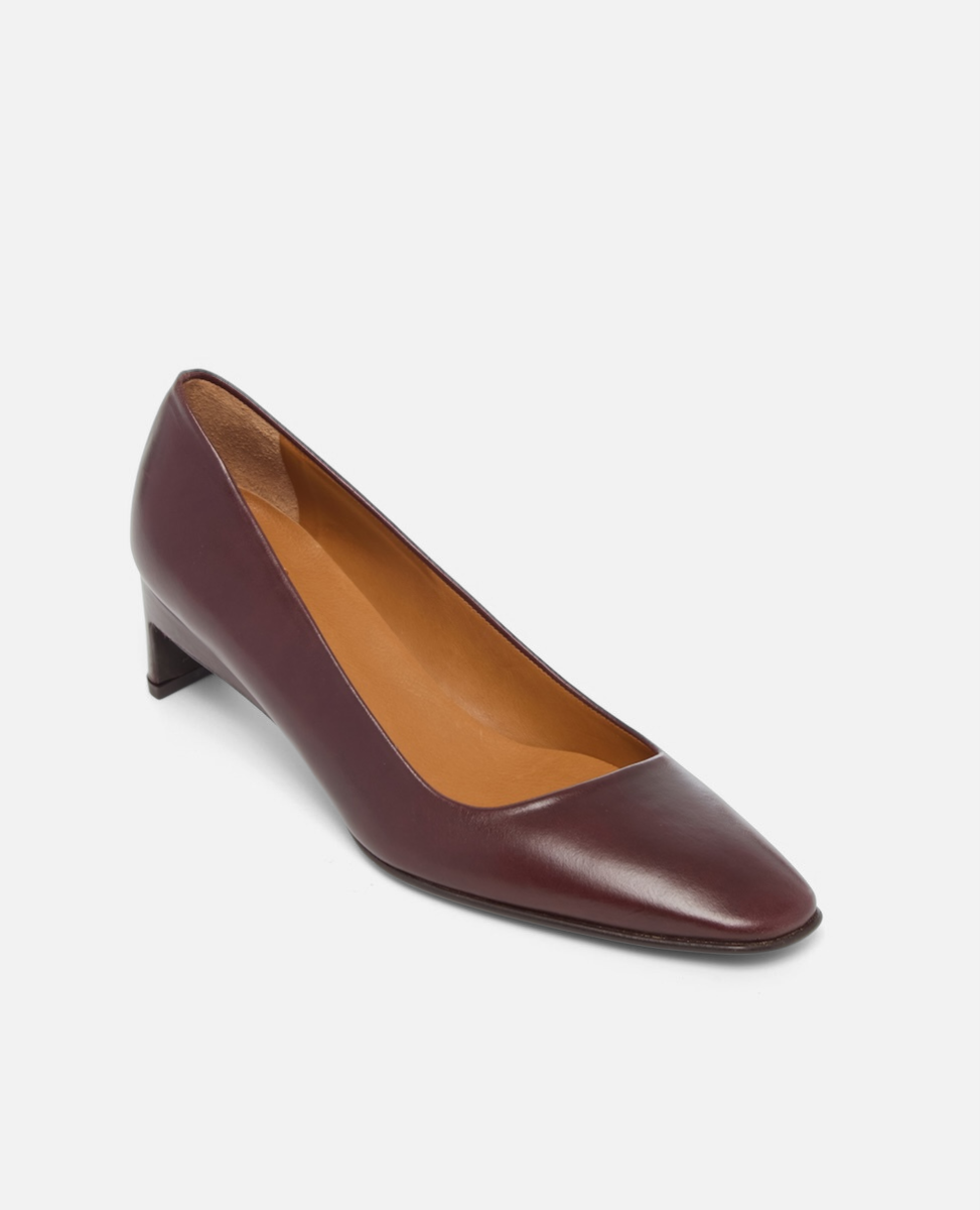 Brown leather shoe on a light gray background