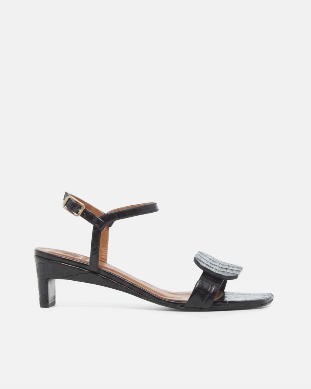 Side view of a black croc-embossed leather sandal with a slim ankle strap, octagonal toe detail, and a low wrapped demi heel on a white background