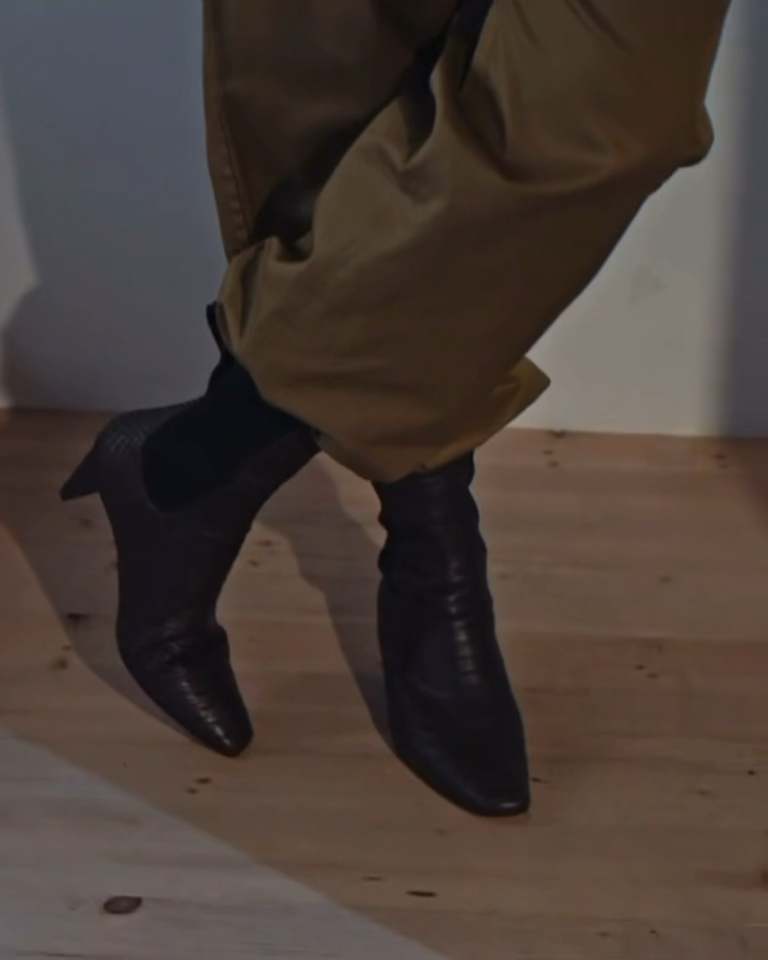Coclico Suttner Boot in Snake Leather worn mo a model wearing a belted jumpsuit