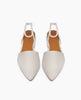 A pair of white, perforated, pointed-toe slingback flats with tan insoles is displayed against a plain white background. 4