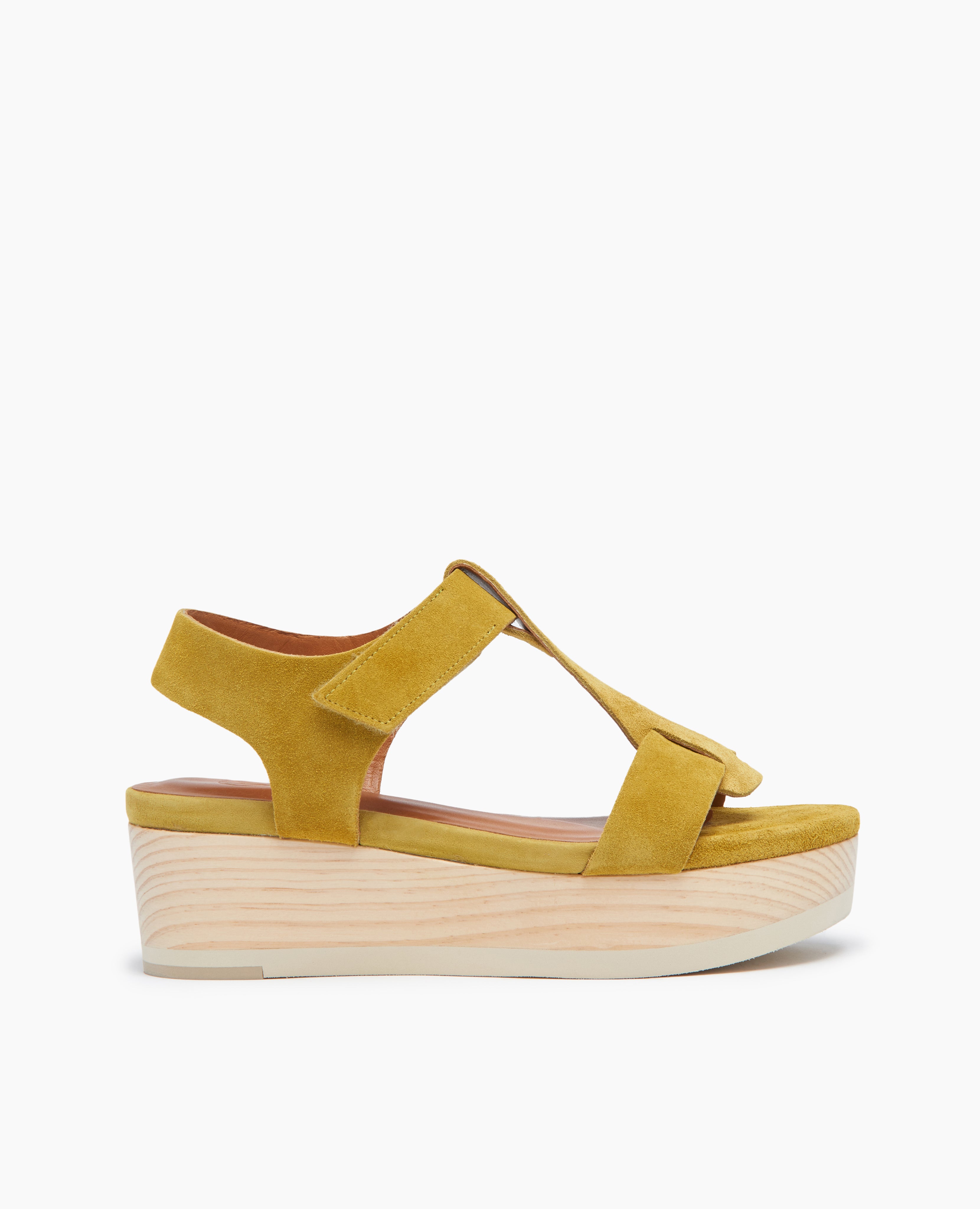 Side view of Coclico Ally Clog in Certosa suede: an open t-strap sandal on solid wood wedge platform with velcro closure.