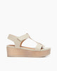 Side view of Coclico Ally Clog in Greige leather: Open t-strap sandal on solid wood wedge platform. Velcro closure. 1