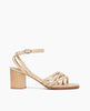 Side view of Coclico Babs Heel in Champagne shimmer suede: open sandal with 6 tubular straps across the foot, ankle strap, buckle closure, wood block mid-height heel. 1