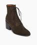 The Bani Boot in Mimetico suede: lace-up bootie featuring a natural stacked leather heel and inside sip. Angled view. 3