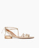 Side view of Coclico Cat Sandal in Champagne shimmer suede: Flat gladiator style sandal with narrow leather straps across foot and ankle, lace up, tie closure. 1