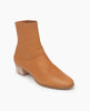Coclico Caviar Boot in Mandorla leather, a simple, modern boot with a low-height wood block heel, inside zip closure and tall shaft height - angle view. 8