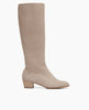 Side view: Coclico Chip Boot in Limestone nubuck, a knee-high boot with an inside zip closure, elastic goring, seam detailing across arch and a low-height solid wood block heel. 1