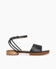 Side view of Coclico Erren Sandal in Deep Sea (almost black) leather: open sandal with leather front band, tubular ankle strap that crisscrosses behind the heel, raised two-part wood and leather sole. 1