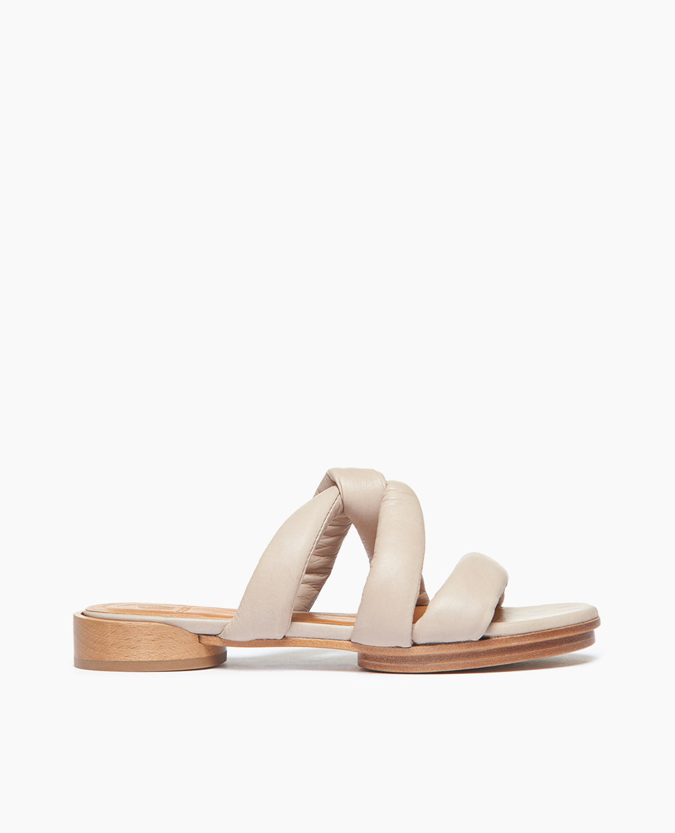Side view of Coclico Everly Sandal in Grey Mist leather: open sandal with padded straps in a twist across arch, raised two-part leather sole.