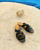 The Coclico Everly sandal on a stone table with a shell behind them. 5