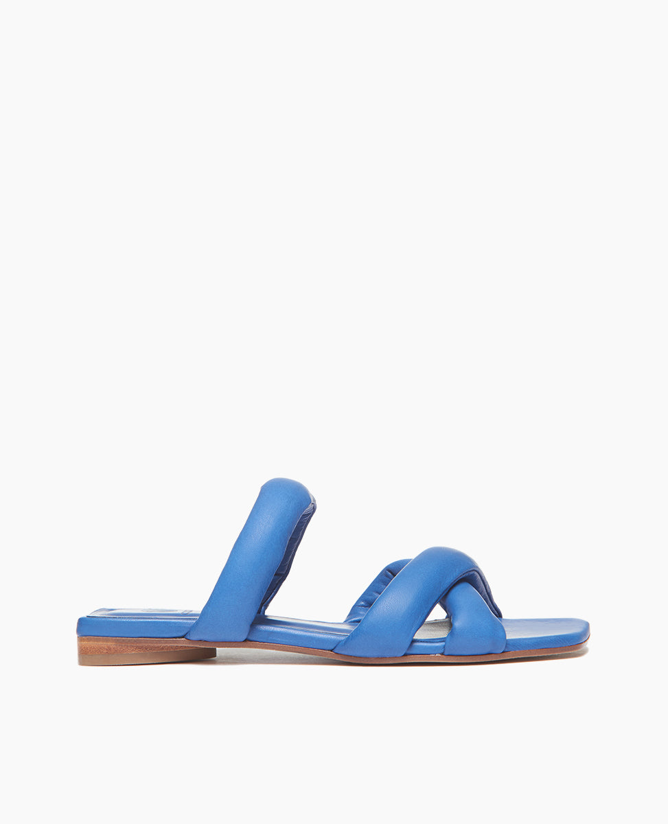 Side view of Coclico Fanima Sandal in Blu Estate leather: Slide with squared-off toe and heel, tubular padded straps, flat feel.