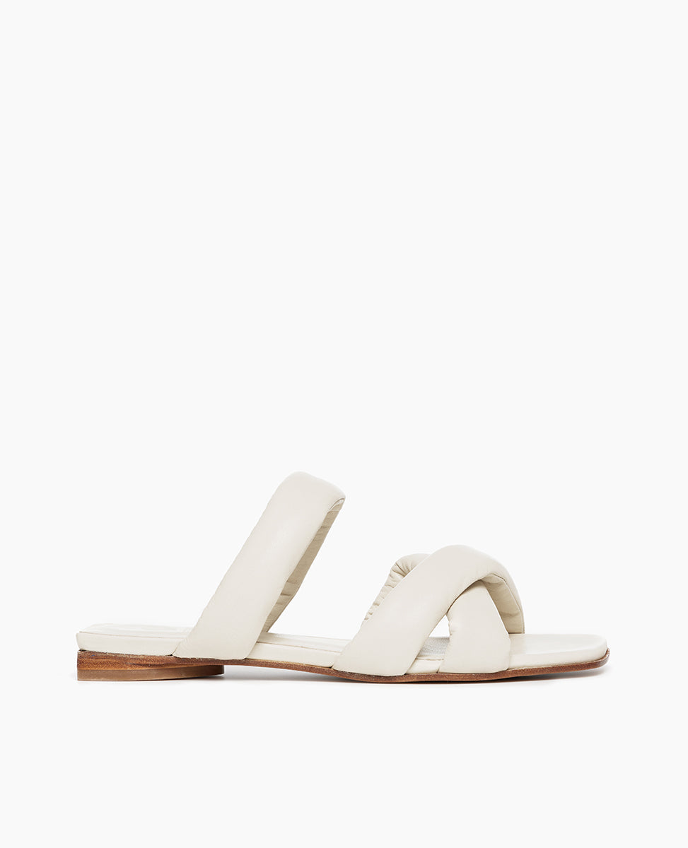 Side view of Coclico Fanima Sandal in Greige leather: Slide with squared-off toe and heel, tubular padded straps, flat feel.
