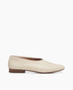 Side view: Coclico Haloumi Flat in Greige leather: a slip-on, form-fitting flat in Italian certified sustainable leather with a squared-off toe and a 10mm solid wood heel. 1