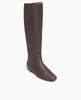 Angle view of the Coclico Haricot Boot in Espresso leather: a flat-heeled, knee-high boot with an inside zip closure and seam detailing. 2