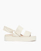 Side view of Coclico Imna Wedge in Greige leather: open wedge with 2 tubular straps across foot, elasticated slingback strap, mid-height EVA flatform sole. 1