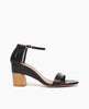 Side view of Coclico Iris Heel in Black leather: 3 thin straps across front of the foot, fan effect of straps cupping heel, leather-wrapped demi-wedge, walnut wood heel. 1