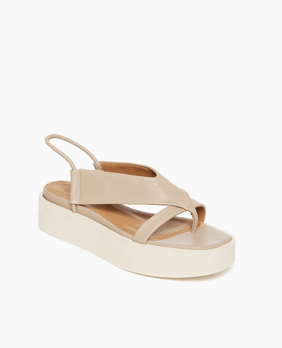 Coclico Iryna Wedge in Grey Mist leather, angled view: V-shaped thong wedge with a slim, tubular elasticated slingback strap, EVA flatform sole.