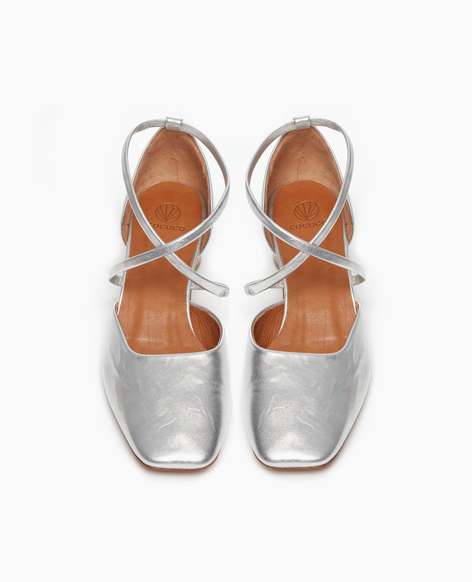 Front view of the Isabel Mary Jane in Milky Way leather: featuring criss-cross-straps with a sculptural mid-height heel and a squared-off, angular toe character.