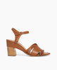 Side view of Coclico Ivy Heel in Cuoio leather: a leather-wrapped demi-wedge heel, carved out strap across foot, quarter strap, buckle closure, mid-height curved walnut wood heel. 1