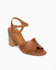 Coclico Ivy Heel in Cuoio leather, angled view: a leather-wrapped demi-wedge heel, carved out strap across foot, quarter strap, mid-height curved walnut wood heel, buckle closure. 2