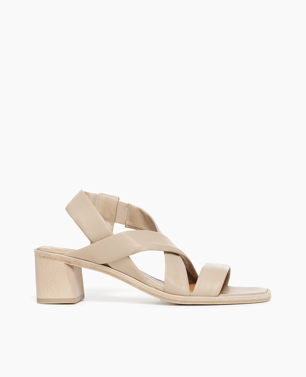 Side view of Coclico Jade Heel in Grey Mist leather: open slip on sandal with leather tube straps across the foot, ankle strap, wood block mid-height heel.