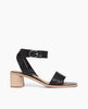 Coclico Jagua Heel in Black leather, side view: a mid-height block wood heel with a leather strap across foot, buckle closure, ankle strap. 1