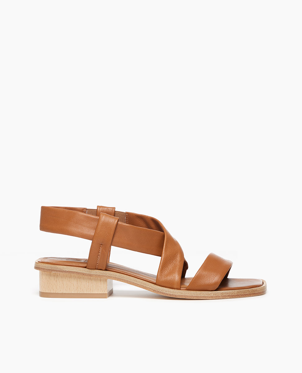Side view of Coclico Kestyn Sandal in cuoio leather: open sandal with tubular straps across foot and ankle, wide wood low-heel.