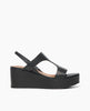 Side view of Coclico Lion Wedge in Deep Sea (blue/black) leather, a full coverage t-strap wedge with elasticized leather slingback strap with a leather wrapped cork platform. 1