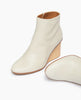 Coclico Lodi Boot in Greige leather - one boot in angle view & one boot laying on floor. 3