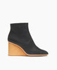 Side view of the Coclico Lodi Boot in Black leather: a solid-wood, sculpted, inset 75mm height wedge with inside zip closure, seam detail on top of foot and rounded toe. 1