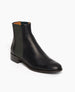 Angled view of the Coclico Medlar Boot in Black. Side view featuring wool elastic gore in a deep forest green, adding an elegant dash of color. 2
