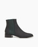 Coclico Medlar Boot in Black. Side view featuring wool elastic gore in a deep forest green, adding an elegant dash of color. 1