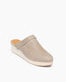 The Coclico Milk Clog in Limestone nubuck, angle view: Clog mule with a rounded toe, low-height solid wood block platform and a decorative ankle strap across top of foot .   5