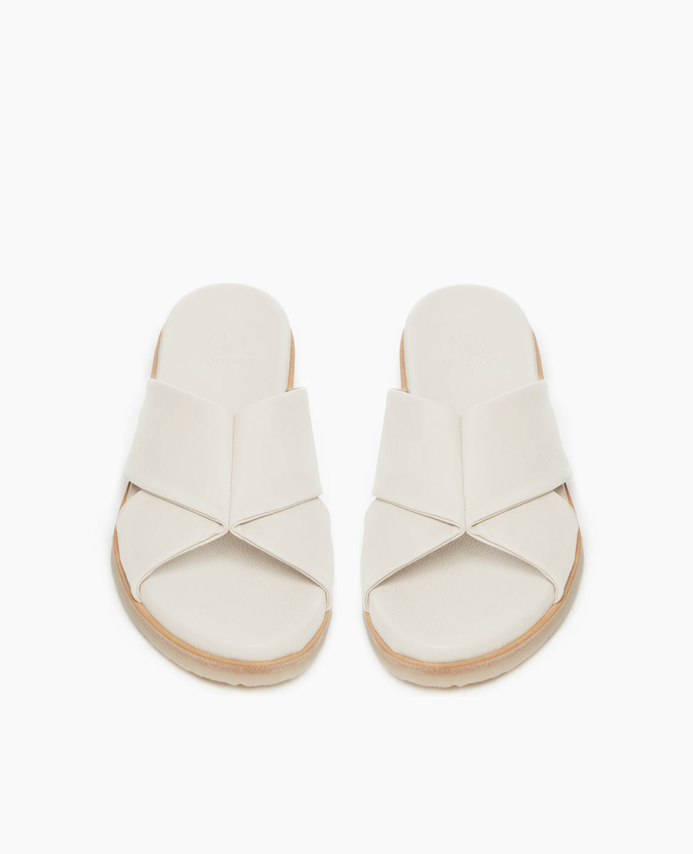 Coclico Pasque Sandal in Greige (off-white) leather: low pine wedge slide sandal, rubber sole, intertwined leather tube straps across foot - top view.