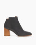 Pavlova Boot in Black leather, a pull-on boot with an asymmetric topline, mid-height solid wood block heel, tonal elastic gore on inside of boot and a softly squared-off toe.  1