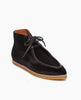 Angled side view of the Coclico Quinn Boot sophisticated chukka bootie in our limited edition black lux hair. Gentilly pointed moc toe, raised black leather piping and lace closure. Inside you'll discover a 30MM hidden wedge that adds height and comfort. 3