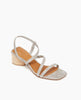 Angle view: Coclico Shirin Heel in Platino Emboss leather: an open sandal with textured leather asymmetrical string-like straps across foot, solid mid-height wood heel. 2